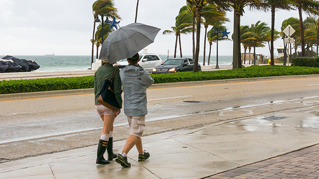People walking in tropical storm